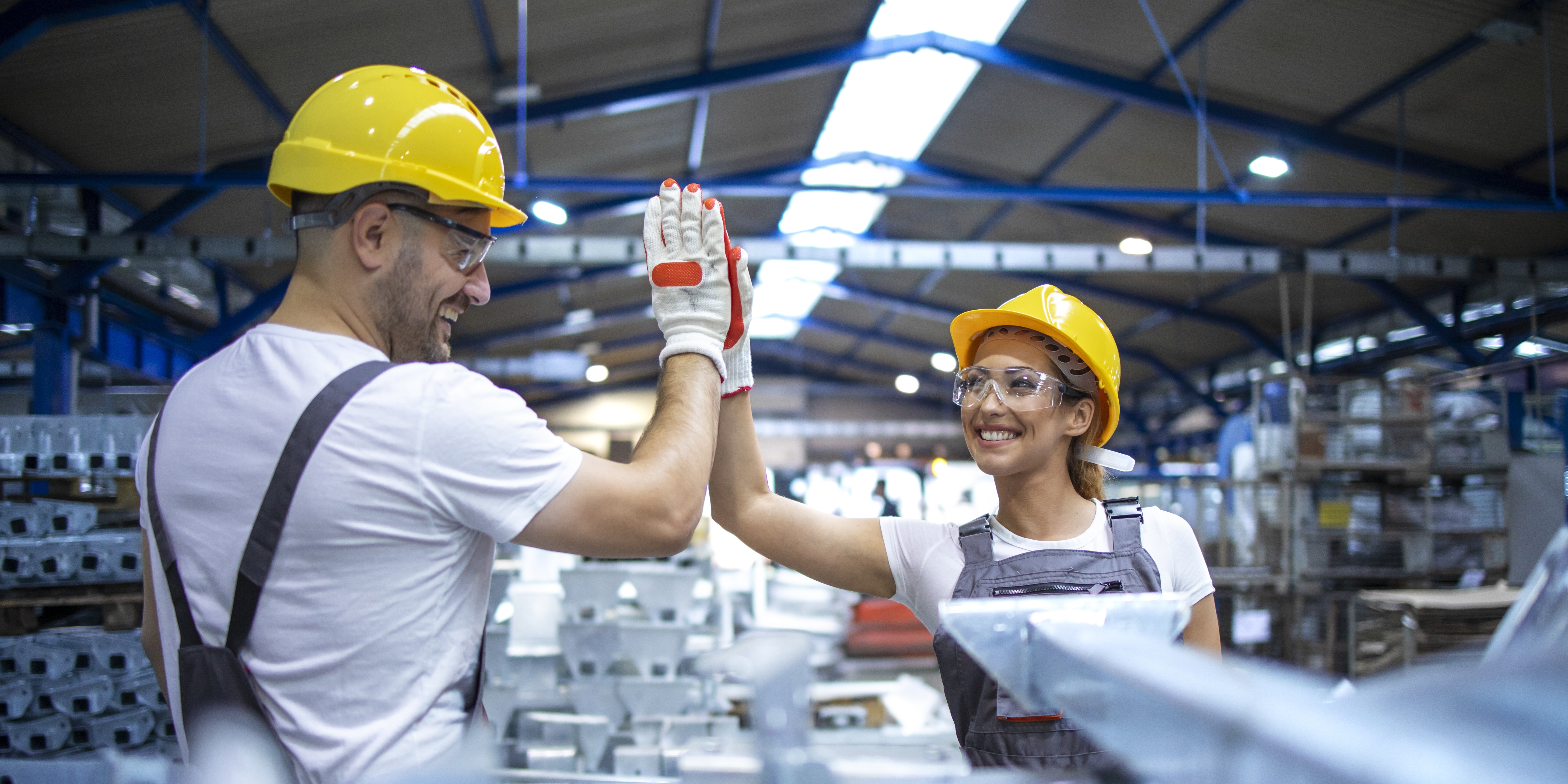factory-workers-greeting-each-other-successful-teamwork